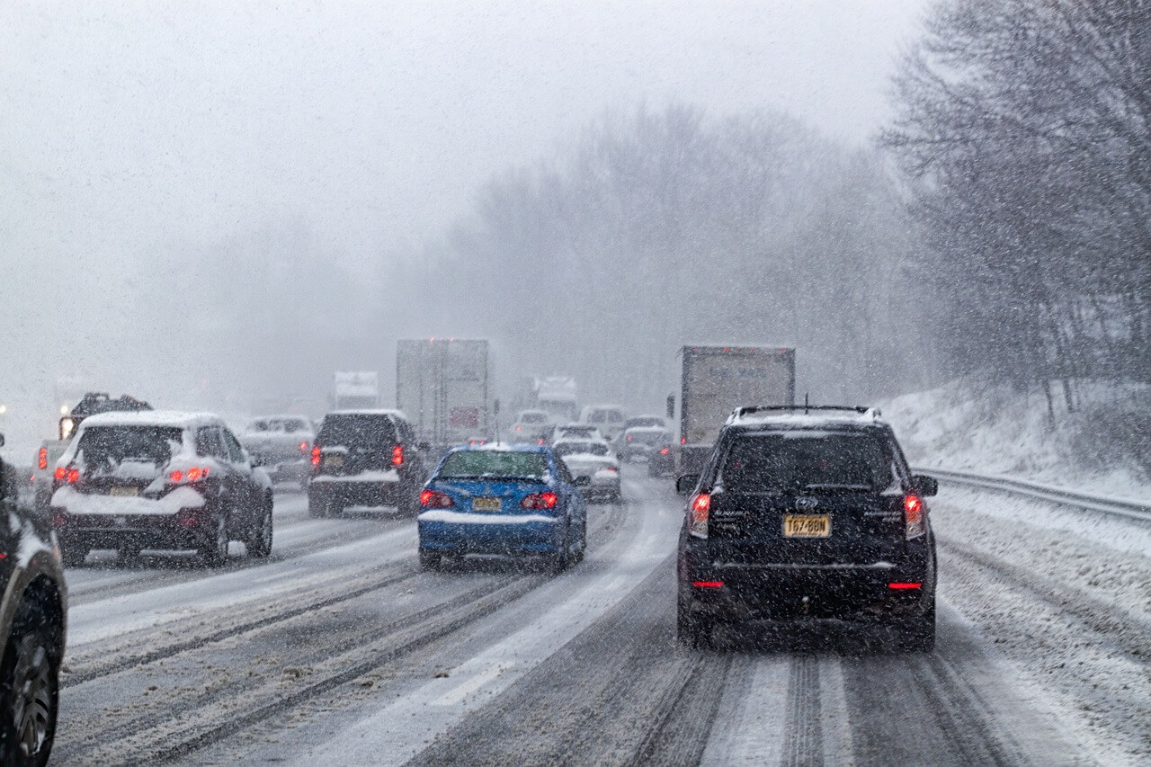 snowy cars driving in winter weather