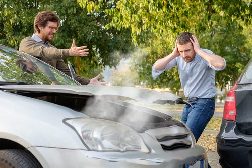 people arguing after a car accident